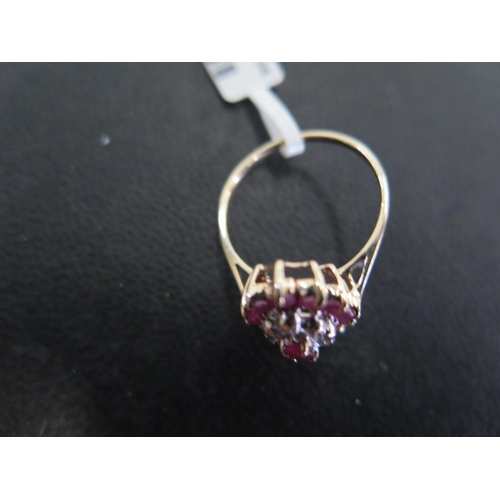 885 - A 9ct yellow gold ruby and diamond cluster ring size N - approx weight 2.3 grams - some light surfac... 