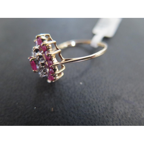 885 - A 9ct yellow gold ruby and diamond cluster ring size N - approx weight 2.3 grams - some light surfac... 