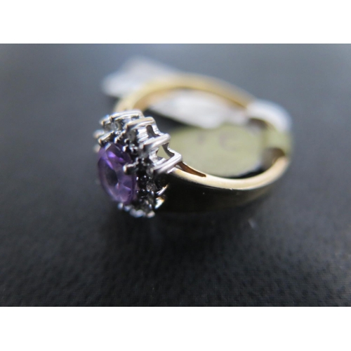 886 - A 9ct yellow gold amethyst and diamond cluster ring size M/N - approx weight 2.4 grams - in good con... 