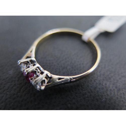 887 - An 18ct yellow gold and platinum ruby and diamond ring size S/T - approx weight 2.1 grams - some lig... 