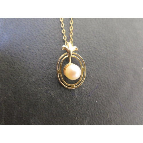 906 - A 9ct yellow gold pearl pendant on a gilt chain, possibly 9ct - total weight approx 1.6 grams