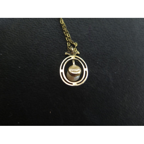 906 - A 9ct yellow gold pearl pendant on a gilt chain, possibly 9ct - total weight approx 1.6 grams