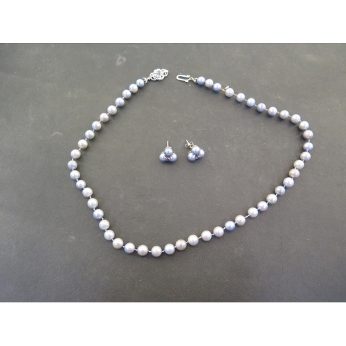 907 - A coloured pearl necklace with earrings, the clasp marked 750, 49cm long, pearls approx 6mm diameter