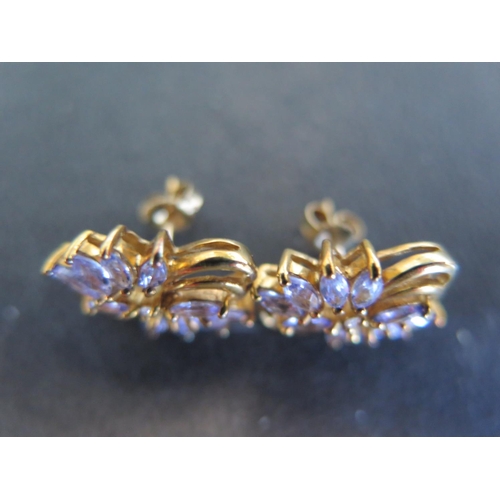 911 - A pair of 9ct gold tanzanite set earrings - in good condition