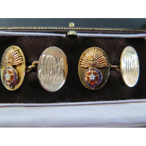 913 - A pair of 9ct yellow gold cufflinks with Royal Fusilliers London Regiment Insignia and a tie pin wit... 