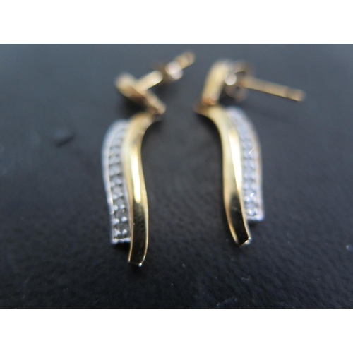 914 - A pair of 9ct gold diamond drop earrings - total diamond weight approx 0.17ct - in good condition