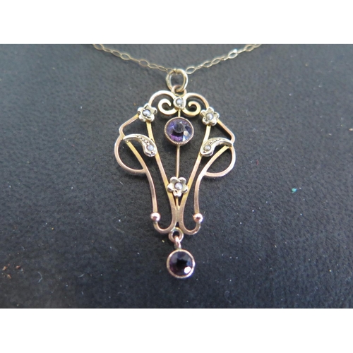 928 - An Art Nouveau style pendant set with amethyst and seed pearls on chain - Length 44cm - total weight... 