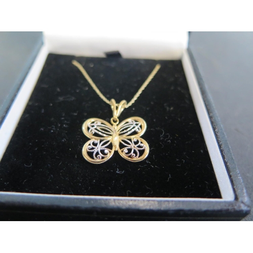 934 - A 10ct two coloured gold butterfly pendant on 10ct chain - chain length approx 45cm - total weight a... 