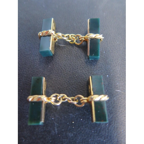 944 - A pair of green stone 9ct gold mounted cufflinks - some light usage wear