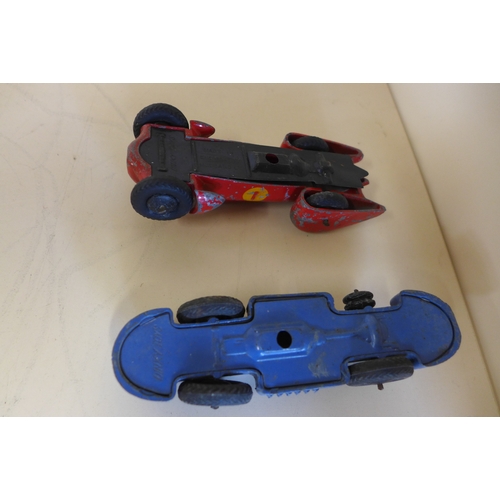 1151 - Two small tinplate clock work motorcycles 9cm long and two Dinky race cars - some play wear to all, ... 