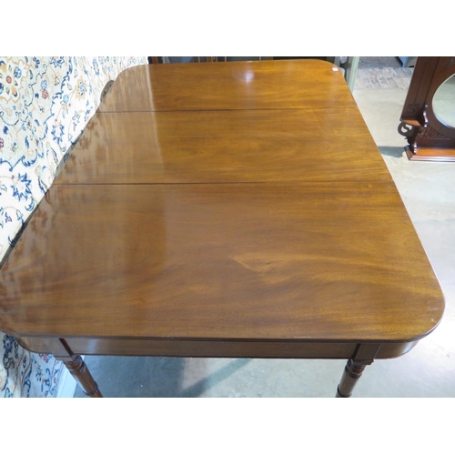 395 - A William IV mahogany dining table with additional leaf, turned legs and brass casters, approximatel... 