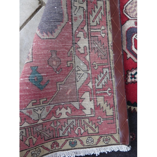 478 - A hand knotted woollen rug with a blue field and geometric design - 143cm x 290cm approx