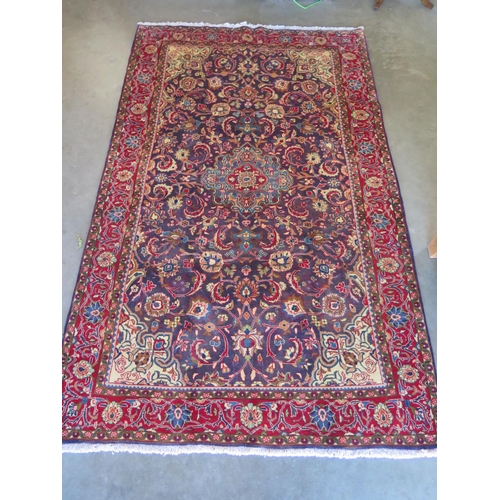 476 - A red ground Kashmir and rug, approximately 214 cm x 132 cm, in good condition