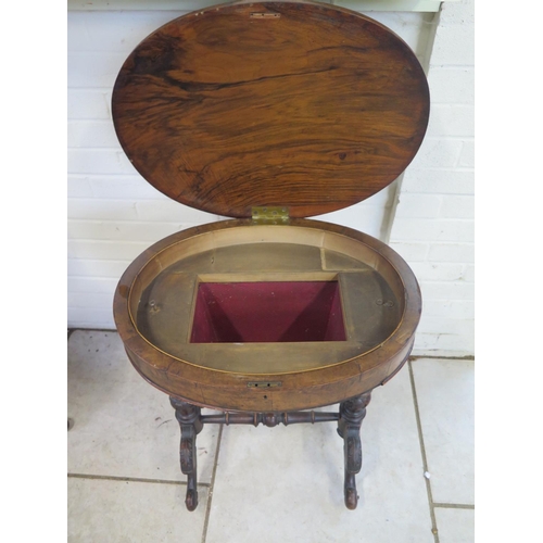 241 - A Victorian walnut work box with an oval top, turned columns and carved supports, interior void need... 