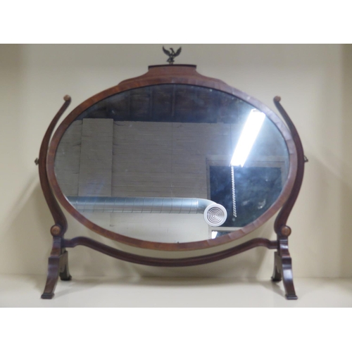 234 - A 19th Century oval dressing table mirror on stand with boxwood and ebony inlaid borders and a Ho Ho... 