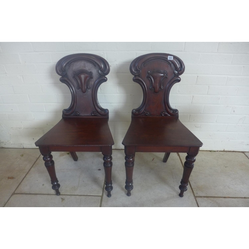 235 - A pair of 19th Century mahogany hall chairs, both in clean condition