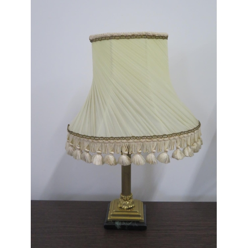 78 - A brass table lamp with a Corinthian column mounted on an Onyx base, with period shade, 48cm H