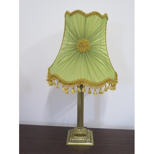 79 - A 1960s brass table lamp of Corinthian column form, with period shade - 60cm high - indentation to b... 