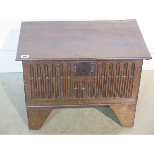 162 - An 18th Century oak box with a carved front on angular feet, 42cm H x 58cm x 36cm - with good colour... 