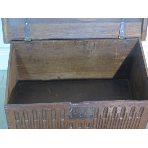 162 - An 18th Century oak box with a carved front on angular feet, 42cm H x 58cm x 36cm - with good colour... 