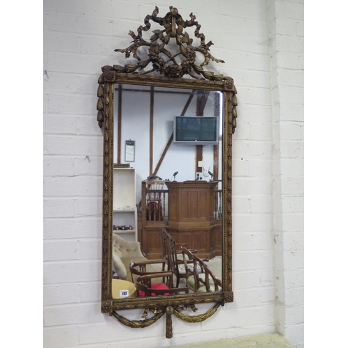 182 - A 19th Century ornate wall mirror with ribbon and swag decoration - 125cm H x 55cm W