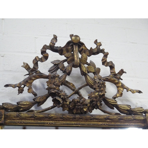 182 - A 19th Century ornate wall mirror with ribbon and swag decoration - 125cm H x 55cm W