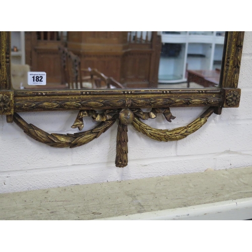 182 - A 19th Century ornate wall mirror with ribbon and swag decoration - 125cm H x 55cm W