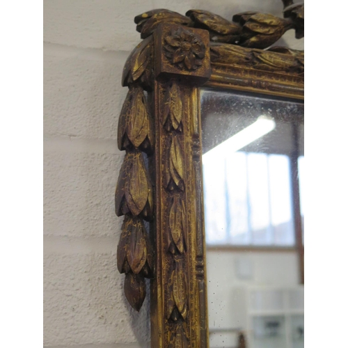 182 - A 19th Century ornate wall mirror with ribbon and swag decoration - 125cm H x 55cm W