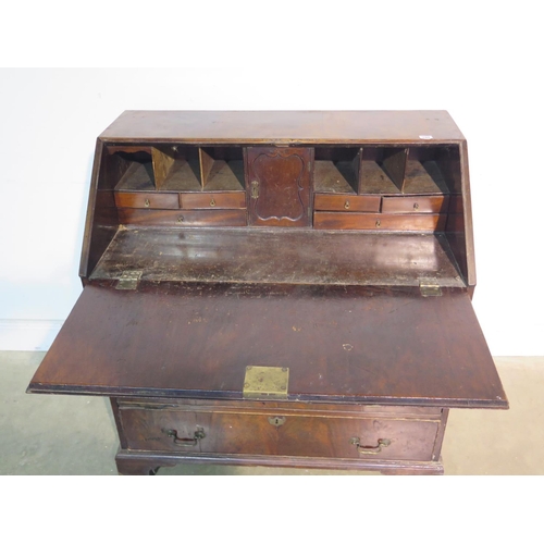 194 - A Georgian mahogany bureau with a fitted interior over four long graduating drawers on bracket feet,... 