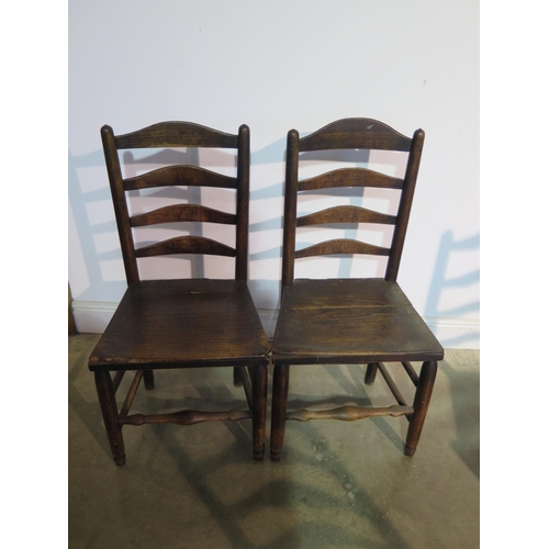 196 - Seven 19th Century ladder back chairs all with solid seats to include three matching, a pair and two... 