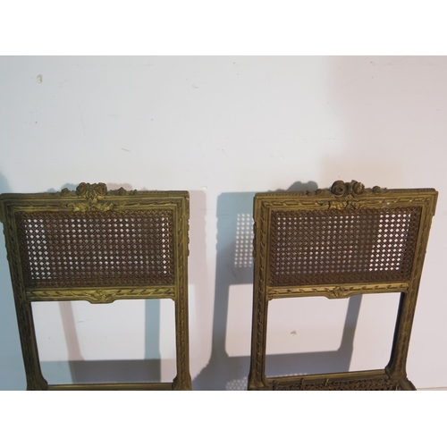 197 - A pair of gilt side chairs with cane seats and backs, caning good to one chair, slight wear to other