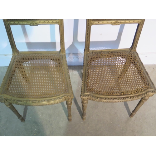 197 - A pair of gilt side chairs with cane seats and backs, caning good to one chair, slight wear to other