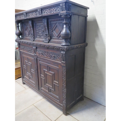 200 - An 18th/19th Century carved oak two section court cupboard with a three door top above a two drawer,... 