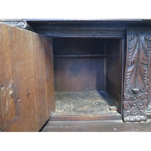 200 - An 18th/19th Century carved oak two section court cupboard with a three door top above a two drawer,... 