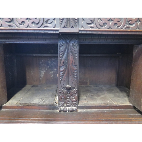 200 - An 18th/19th Century carved oak two section court cupboard with a three door top above a two drawer,... 