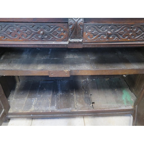 200 - An 18th/19th Century carved oak two section court cupboard with a three door top above a two drawer,... 