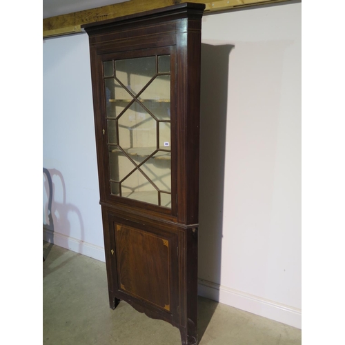 202 - A 19th Century mahogany two part corner cupboard with a glazed door enclosing two shaped shelves and... 