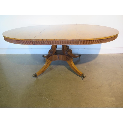 205 - A bespoke rosewood dining table made in the style of William Trotter, on a quatrefoil base, the top ... 