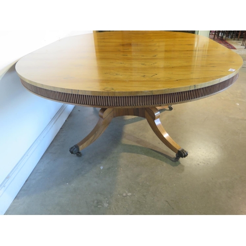 205 - A bespoke rosewood dining table made in the style of William Trotter, on a quatrefoil base, the top ... 