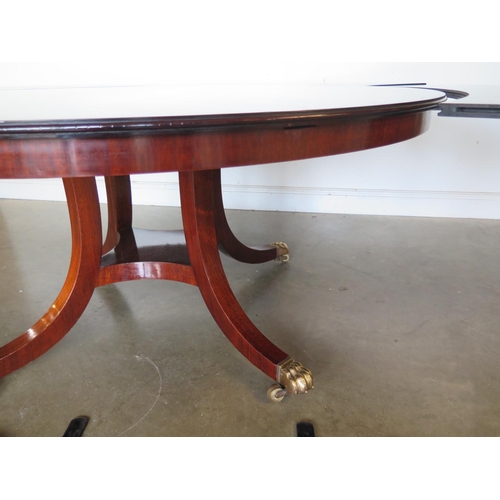 206 - A good quality mahogany extending circular dining table on a quatrefoil base with five leaves by Wil... 