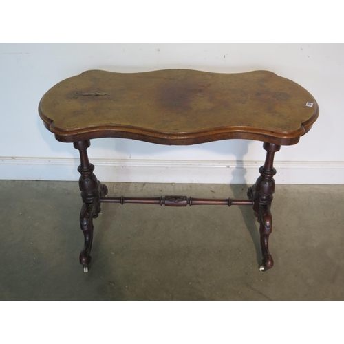 222 - A 19th Century walnut side table with a shaped top on a base with turned carved legs, top damaged wi... 