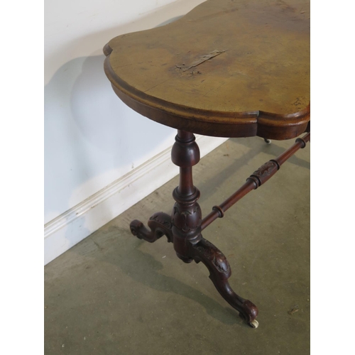 222 - A 19th Century walnut side table with a shaped top on a base with turned carved legs, top damaged wi... 