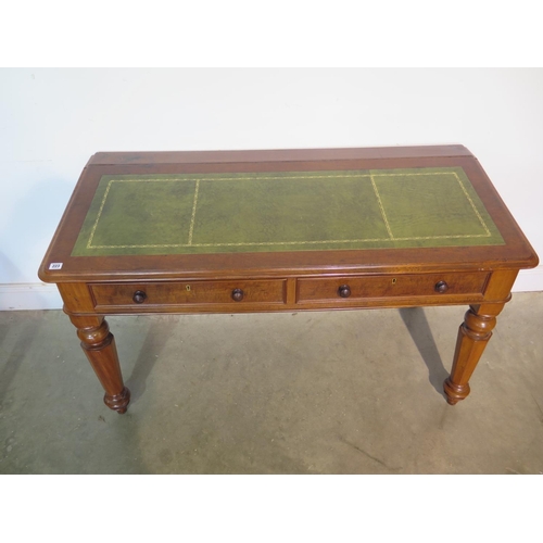 223 - A good quality flame mahogany writing table with a sloping leather inset top over two drawers, raise... 