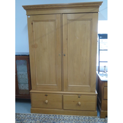 245 - An early 20th Century pine double wardrobe with two doors over the base with two drawers - 230cm x 1... 