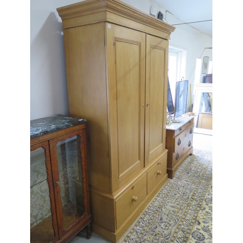 245 - An early 20th Century pine double wardrobe with two doors over the base with two drawers - 230cm x 1... 