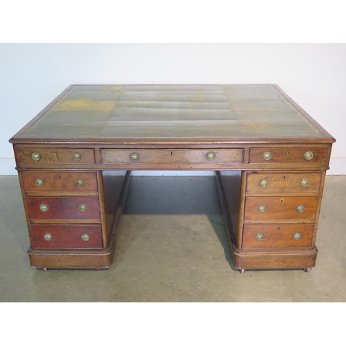 262 - A 19th Century mahogany partners desk with a leather inset top with nine drawers to each side on pli... 