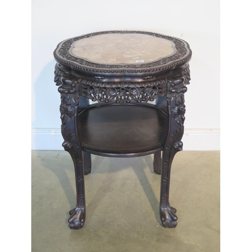 265 - A tall Oriental carved hardwood marble top jardiniere stand with under tier, with good colour and in... 