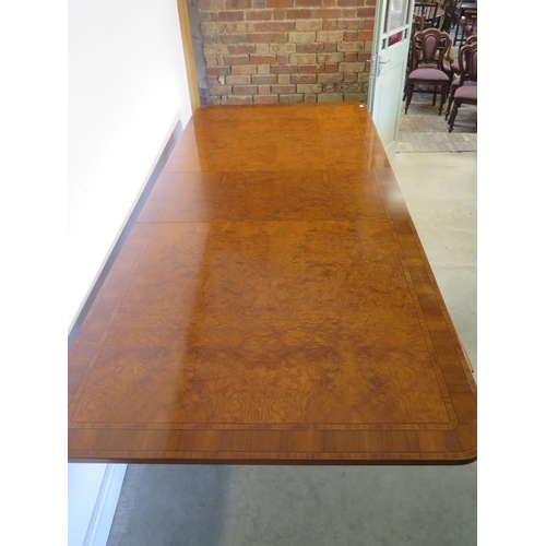 272 - A large walnut and satin wood twin pedestal dining table with two additional leaves, approx 320cm x ... 