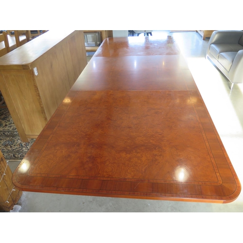 272 - A large walnut and satin wood twin pedestal dining table with two additional leaves, approx 320cm x ... 