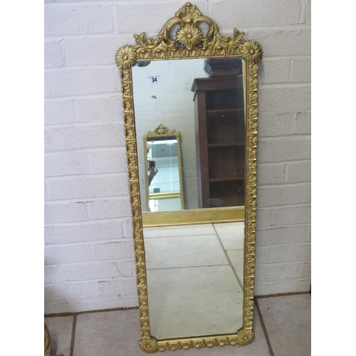 34 - A modern gilt embossed framed mirror, 101cm H x 37cm W